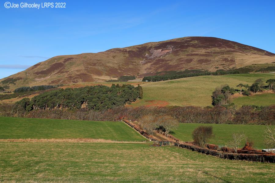 Castlelaw Hill in Pentland Hills with a wonderful winter's blue sky