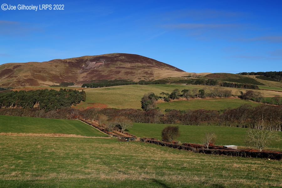 Castlelaw Hill in Pentland Hills with a wonderful winter's blue sky