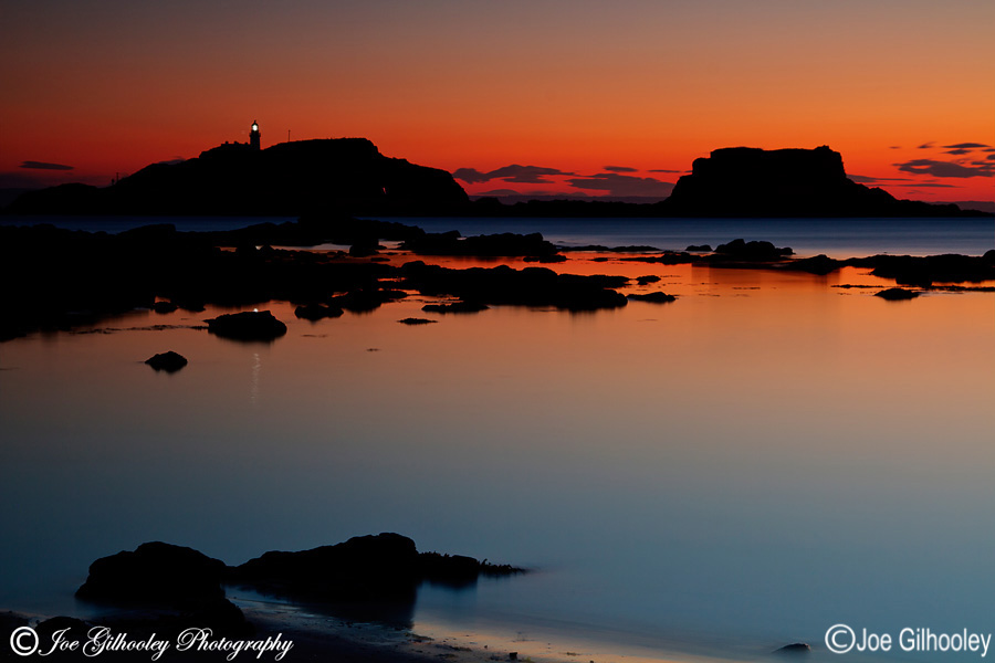 Sunrise at Yellowcraigs Beach. Two hours before dawn. Fidra Island with lighthouse light showing. Getting reflections from lighthouse light.